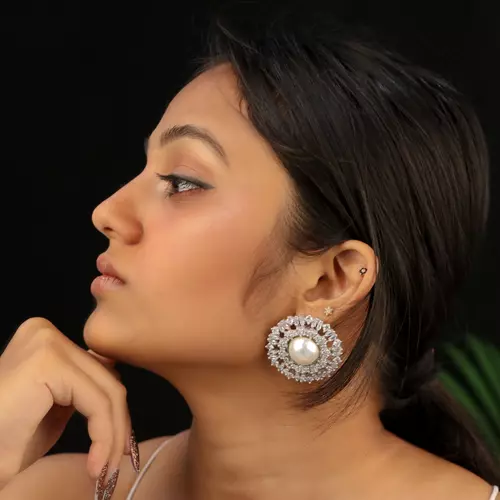 model showcasing earrings